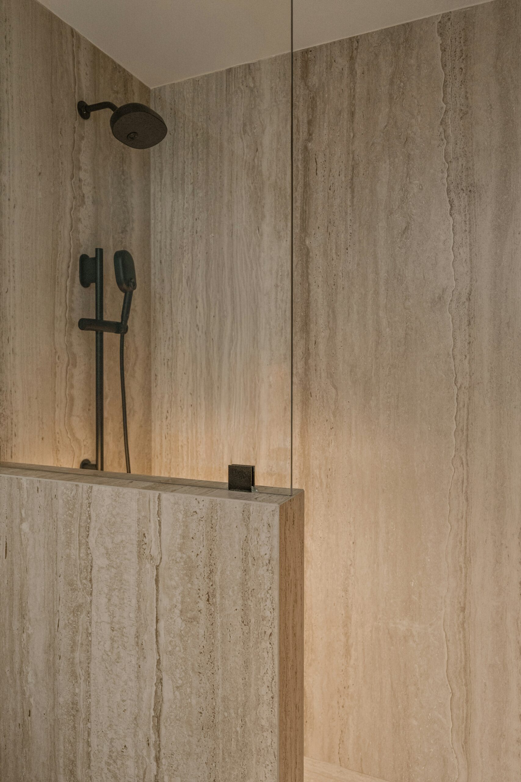 Travertine style stone tiles in a luxury shower